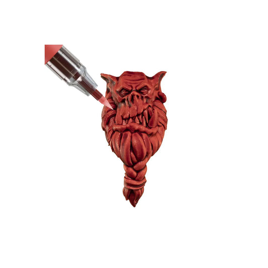 Red devil-shaped bottle stopper on a white background