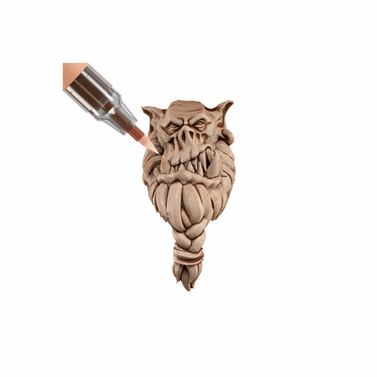 Carved wooden dragon head with a metallic object on a white background