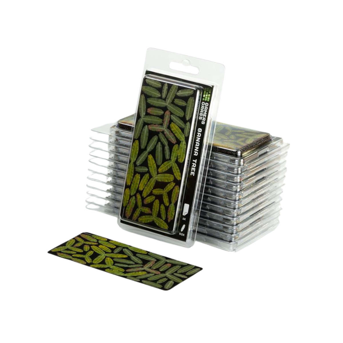A pack of Dragonfly brand Dragonfly Tree deck boxes, with one clear plastic package standing upright showing the green and black leaf pattern, a stack of similar packages behind it, and a single box placed in front on a white background.