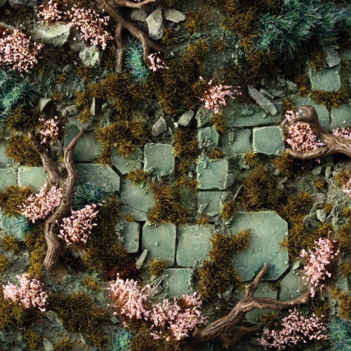 Mossy stone wall with pink flowers and branches