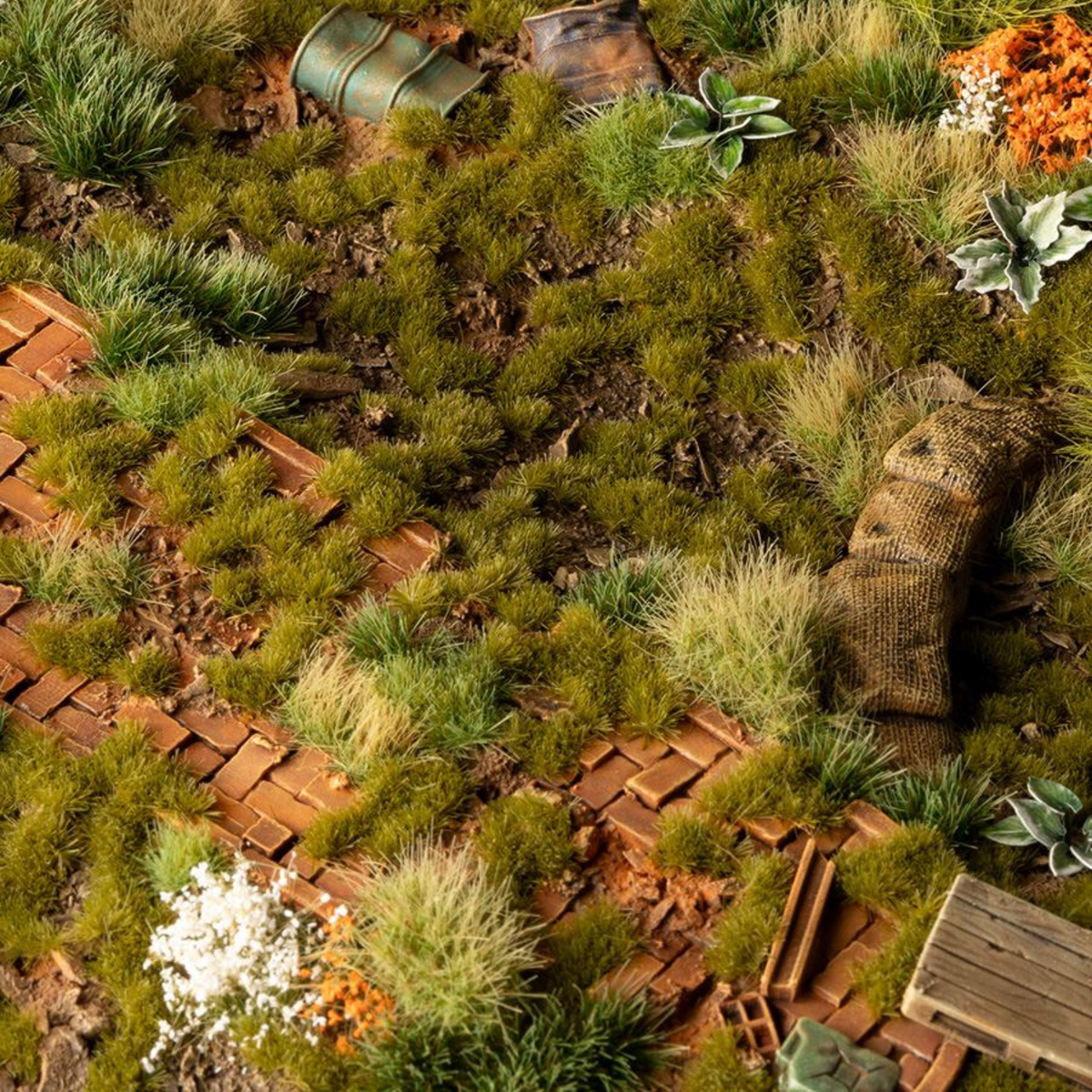 Miniature garden with terracotta pots and greenery on a textured surface