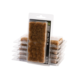 Pack of miniature grass plugs, featuring a large 'Grass Grass Dry Turf XL' package in the center with several smaller packages stacked behind it on a white background.