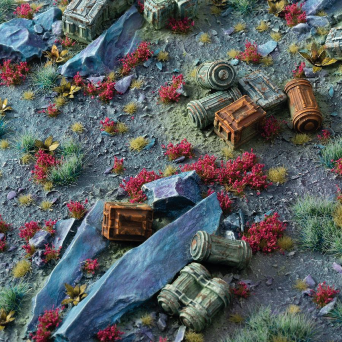 Miniature diorama of a desert landscape with ruins and colorful plants