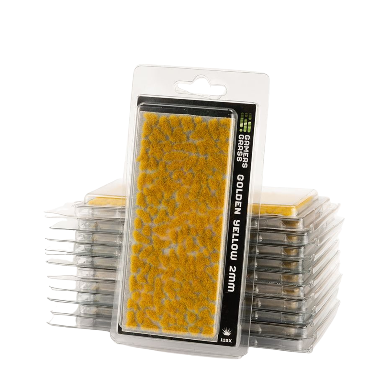 Packaged miniature grass mat in golden yellow, displayed in front of a stack of similar clear plastic packages on a white background.