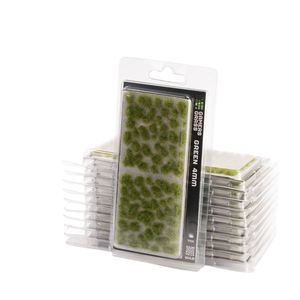 Pack of green 4mm grass pieces for tabletop wargaming, shown in a clear blister pack with a stack of additional packs behind it on a white background.