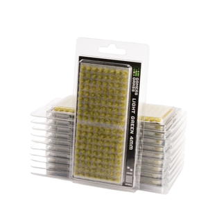 Pack of green grass blades for lawns, with one package in front and several stacks behind it on a white background.
