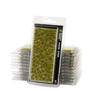 Packaged 3D Effects Grass Fibres in moss green, shown with a single carded pack standing in front of two stacks of smaller clear plastic packs on a white background.