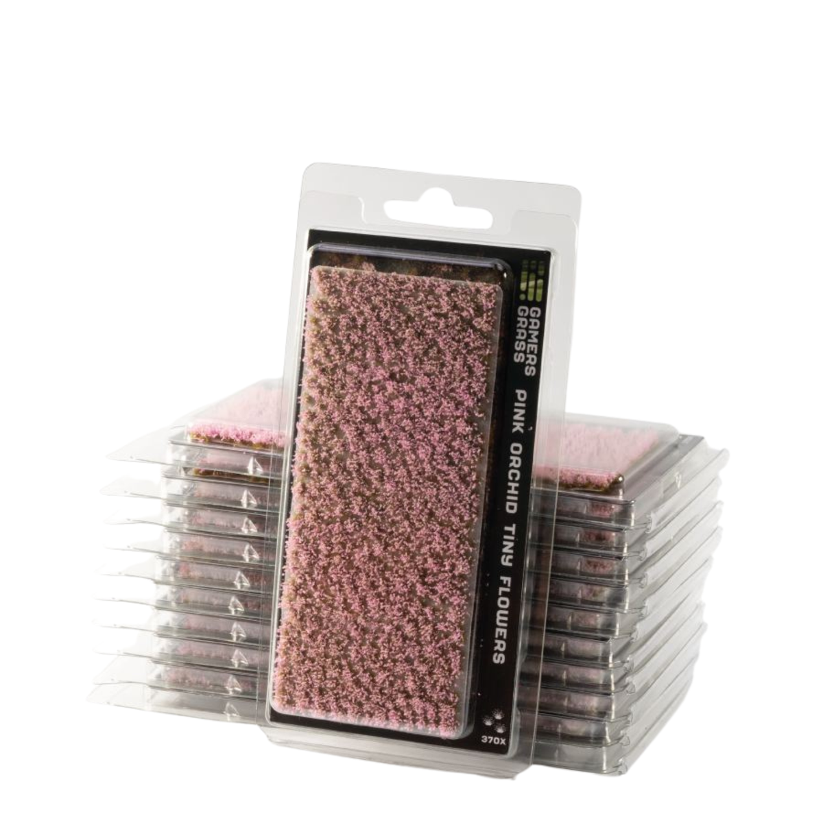 Packaged pink orchid tiny flowers, with one flower in clear plastic blister packaging standing in front of stacks of the same flowers on a white background.