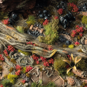 Detailed miniature landscape with rocks, plants, and a small building.