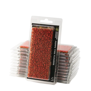 Packaged red poppy ting flowers for tabletop miniature terrain, shown in clear plastic blister packs with a black label, with a stack of similar packs behind the front package.