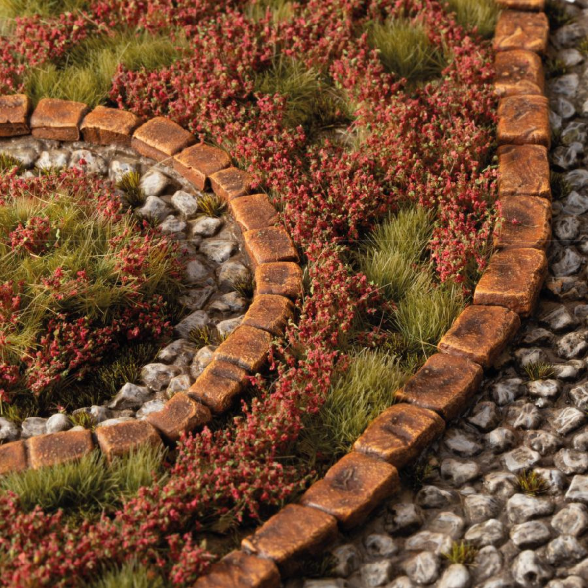 Decorative brick border with plants and stones in a garden setting