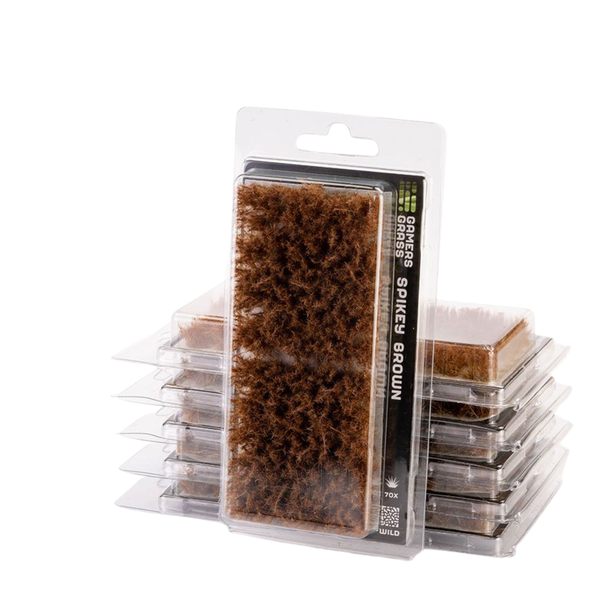 A pack of grass spikes and ground covers in clear plastic clamshell packaging, with one package standing upright in front of a stack of similar packages on a white background.