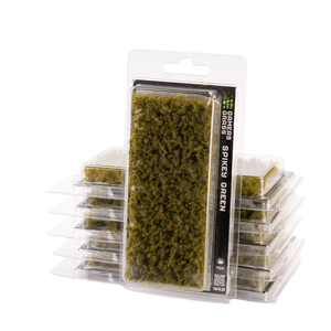 Packaged miniature green spikes moss, shown in a clear blister pack with a white backing card, with additional unopened packs stacked behind it on a white background.