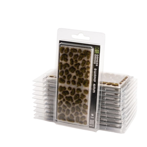 Packaged miniature grass tufts labeled 'Grass Seeds Surpif 4mm' in a clear blister pack, with multiple stacks of the same package behind it on a white background.